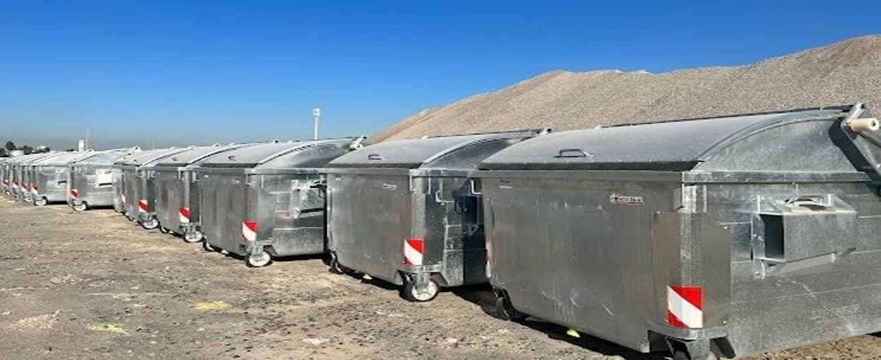 Large industrial garbage bins lined up outdoors on a sunny day, designed for waste collection and management - POWER Bear